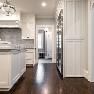 Eat-in kitchen - huge traditional l-shaped dark wood floor and brown floor eat-in kitchen idea in Boston with an undermount sink, beaded inset cabinets, white cabinets, marble countertops, gray backsplash, marble backsplash, stainless steel appliances, an island and white countertops