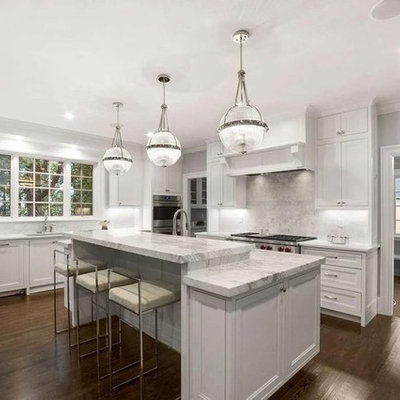 Huge elegant l-shaped dark wood floor and brown floor eat-in kitchen photo in Boston with an undermount sink, beaded inset cabinets, white cabinets, marble countertops, gray backsplash, marble backsplash, stainless steel appliances, an island and white countertops