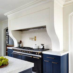 Inspiration for a transitional eat-in kitchen in New York with an undermount sink, beaded inset cabinets, blue cabinets, quartz benchtops, white splashback, ceramic splashback, stainless steel appliances, porcelain floors, multiple islands and multi-coloured floor.