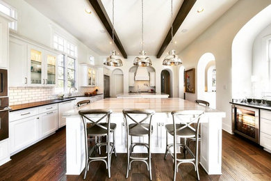 Inspiration for a huge transitional medium tone wood floor eat-in kitchen remodel in Austin with an undermount sink, stainless steel appliances and two islands