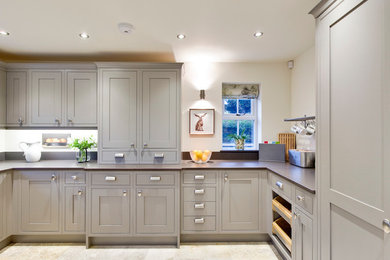 Large classic u-shaped enclosed kitchen in Other with recessed-panel cabinets, grey cabinets, quartz worktops, white splashback, ceramic flooring and no island.