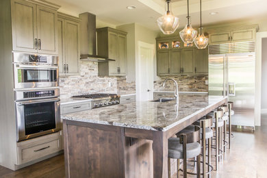 Kitchen - mid-sized contemporary l-shaped dark wood floor and brown floor kitchen idea in Denver with a farmhouse sink, recessed-panel cabinets, distressed cabinets, granite countertops, brown backsplash, stone tile backsplash and stainless steel appliances