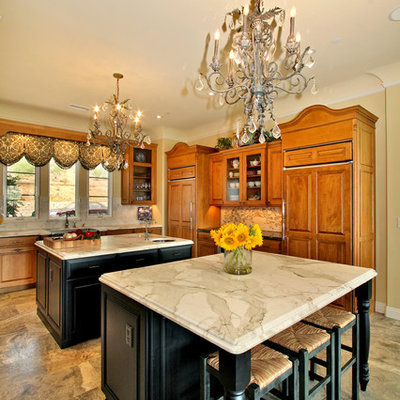 Elegant kitchen photo in San Diego with marble countertops and two islands