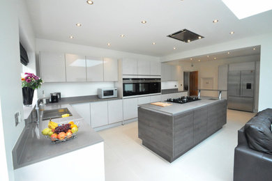 Large contemporary kitchen in Buckinghamshire with a submerged sink, quartz worktops and an island.
