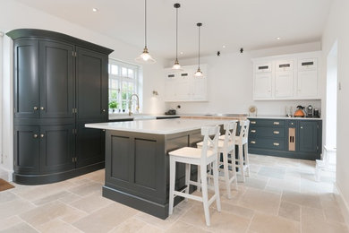 Inspiration for a large rural l-shaped kitchen/diner in Essex with a belfast sink, recessed-panel cabinets, blue cabinets, quartz worktops, stainless steel appliances, ceramic flooring, an island and beige floors.