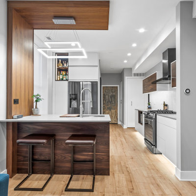 Example of a mid-sized trendy u-shaped open concept kitchen design in Chicago with an undermount sink, flat-panel cabinets, white cabinets, quartz countertops, white backsplash, cement tile backsplash, stainless steel appliances, a peninsula and gray countertops