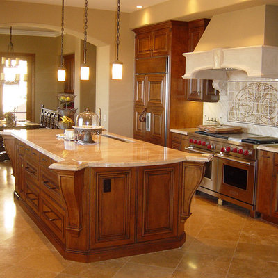 Example of a classic eat-in kitchen design in Orange County with an undermount sink, beaded inset cabinets, medium tone wood cabinets and stainless steel appliances