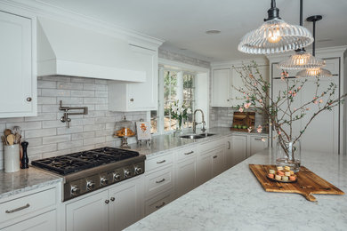 This is an example of a classic kitchen in Boston with white cabinets and engineered stone countertops.