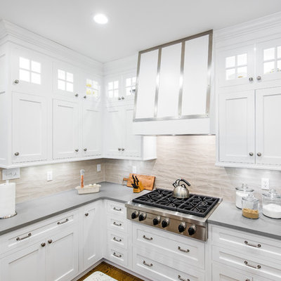 Mid-sized elegant u-shaped dark wood floor enclosed kitchen photo in Boston with an undermount sink, shaker cabinets, stainless steel appliances, an island, white cabinets, granite countertops, beige backsplash and porcelain backsplash