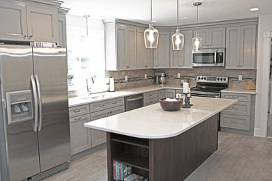 Medium sized classic l-shaped kitchen in Boston with a submerged sink, shaker cabinets, grey cabinets, quartz worktops, multi-coloured splashback, ceramic splashback, stainless steel appliances, ceramic flooring and an island.