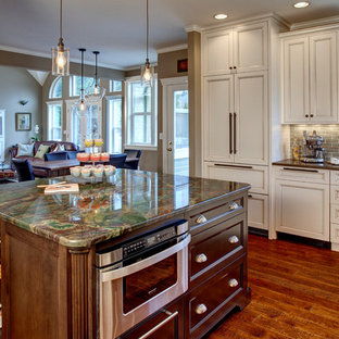 Elegant u-shaped eat-in kitchen photo in Seattle with an undermount sink, recessed-panel cabinets, white cabinets, subway tile backsplash, paneled appliances, granite countertops and gray backsplash