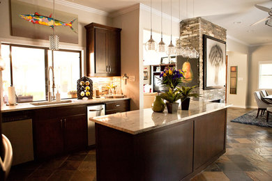 Example of a mid-sized transitional u-shaped eat-in kitchen design in Dallas with an undermount sink, recessed-panel cabinets, dark wood cabinets, marble countertops, gray backsplash, glass tile backsplash, stainless steel appliances and an island