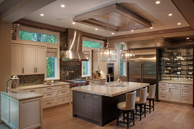 Example of a large transitional l-shaped eat-in kitchen design in Tampa with recessed-panel cabinets, beige cabinets, quartz countertops, stainless steel appliances, an island and a farmhouse sink
