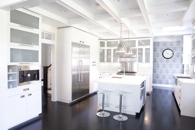 Eat-in kitchen - mid-sized traditional l-shaped dark wood floor and brown floor eat-in kitchen idea in San Francisco with a farmhouse sink, glass-front cabinets, white cabinets, white backsplash, subway tile backsplash, stainless steel appliances and an island