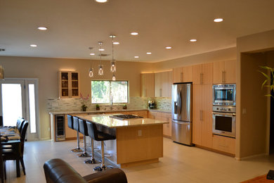 Eat-in kitchen - large contemporary l-shaped porcelain tile and beige floor eat-in kitchen idea in Phoenix with an undermount sink, flat-panel cabinets, light wood cabinets, granite countertops, multicolored backsplash, matchstick tile backsplash, stainless steel appliances and an island