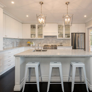 Photo of a transitional l-shaped kitchen in Melbourne with an undermount sink, shaker cabinets, white cabinets, grey splashback, stainless steel appliances, dark hardwood floors, with island, brown floor and white benchtop.