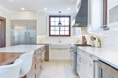 Example of a large arts and crafts l-shaped ceramic tile and beige floor eat-in kitchen design in Other with a farmhouse sink, recessed-panel cabinets, light wood cabinets, quartz countertops, white backsplash, ceramic backsplash, stainless steel appliances and an island