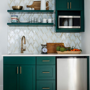 This is an example of a small transitional single-wall open plan kitchen in Seattle with an undermount sink, shaker cabinets, green cabinets, quartz benchtops, white splashback, marble splashback, stainless steel appliances, laminate floors, no island and brown floor.