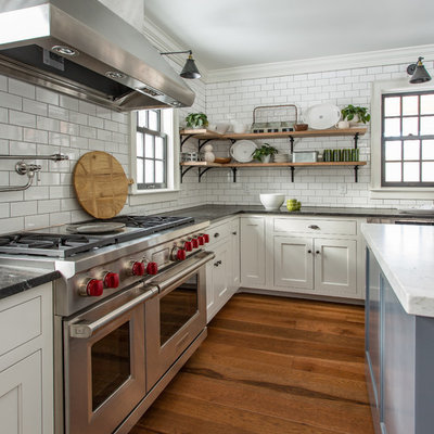 Inspiration for a farmhouse medium tone wood floor kitchen remodel in Boston with recessed-panel cabinets, white cabinets, subway tile backsplash, stainless steel appliances and an island