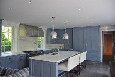 Example of a large classic l-shaped slate floor and gray floor open concept kitchen design in Chicago with blue cabinets, marble countertops, white backsplash, stone slab backsplash, stainless steel appliances, an island, recessed-panel cabinets and an undermount sink