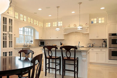 Kitchen - traditional kitchen idea in Chicago with white cabinets and white backsplash
