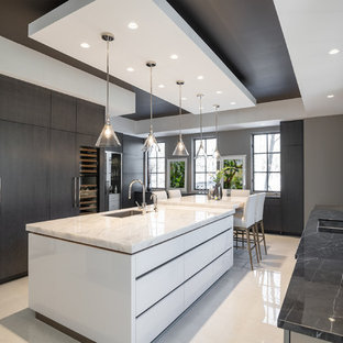 Design ideas for a large contemporary u-shaped separate kitchen in Toronto with flat-panel cabinets, quartzite benchtops, porcelain floors, with island, white floor, a single-bowl sink, white cabinets, white splashback, stone slab splashback, stainless steel appliances and white benchtop.