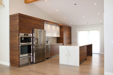 Example of a mid-sized trendy galley light wood floor, beige floor and exposed beam open concept kitchen design in Vancouver with a drop-in sink, flat-panel cabinets, dark wood cabinets, quartz countertops, multicolored backsplash, quartz backsplash, stainless steel appliances, an island and multicolored countertops