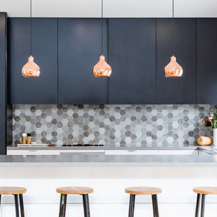 Inspiration for a contemporary u-shaped kitchen in Melbourne with a submerged sink, flat-panel cabinets, black cabinets, grey splashback, mosaic tiled splashback and a breakfast bar.