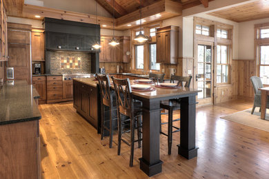 Inspiration for a transitional medium tone wood floor kitchen remodel in Other with an undermount sink, flat-panel cabinets, medium tone wood cabinets, quartz countertops, stone tile backsplash, paneled appliances and an island