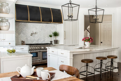 Example of a large classic u-shaped dark wood floor eat-in kitchen design in Detroit with a farmhouse sink, flat-panel cabinets, white cabinets, marble countertops, white backsplash, marble backsplash, stainless steel appliances and an island