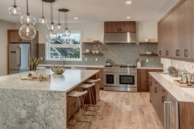 Open concept kitchen - large contemporary u-shaped medium tone wood floor open concept kitchen idea in Seattle with an undermount sink, flat-panel cabinets, medium tone wood cabinets, stainless steel appliances, an island, granite countertops, multicolored backsplash, porcelain backsplash and gray countertops