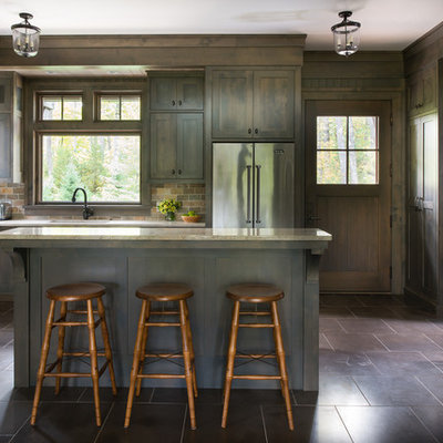 Inspiration for a rustic l-shaped kitchen remodel in Minneapolis with an undermount sink, shaker cabinets, dark wood cabinets, stainless steel appliances, an island, multicolored backsplash and stone tile backsplash