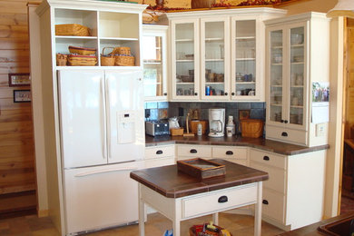 Example of a mountain style ceramic tile kitchen design in Other with flat-panel cabinets, white cabinets, tile countertops, ceramic backsplash, white appliances and an island