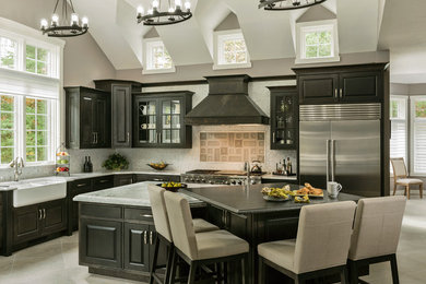 Eat-in kitchen - huge transitional l-shaped porcelain tile, gray floor and vaulted ceiling eat-in kitchen idea in Boston with a farmhouse sink, beaded inset cabinets, black cabinets, quartzite countertops, stone tile backsplash, stainless steel appliances, an island, gray backsplash and gray countertops