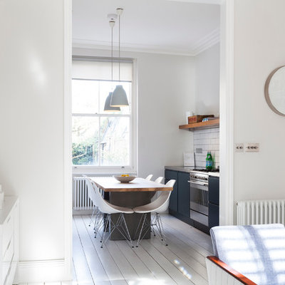 Example of a small danish galley eat-in kitchen design in London