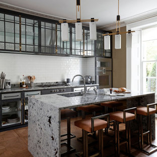 Photo of a medium sized retro single-wall open plan kitchen in London with a built-in sink, glass-front cabinets, black cabinets, marble worktops, grey splashback, marble splashback, integrated appliances, medium hardwood flooring, an island, brown floors and grey worktops.