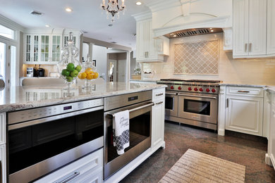 Large elegant u-shaped eat-in kitchen photo in Boston with an undermount sink, raised-panel cabinets, white cabinets, granite countertops, gray backsplash, porcelain backsplash, stainless steel appliances, an island and gray countertops