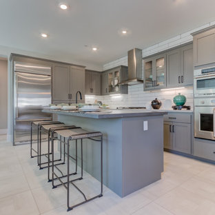 Open concept kitchen designs - Open concept kitchen - l-shaped beige floor open concept kitchen idea in San Francisco with an undermount sink, recessed-panel cabinets, white backsplash, stainless steel appliances and an island
