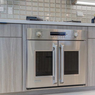 Open concept kitchen ideas - Example of a single-wall open concept kitchen design in San Francisco with an undermount sink, light wood cabinets, paneled appliances and an island