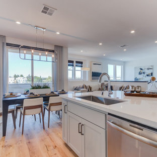 Open concept kitchen pictures - Inspiration for a l-shaped open concept kitchen remodel in San Francisco with an undermount sink, recessed-panel cabinets, gray cabinets, stainless steel appliances and an island