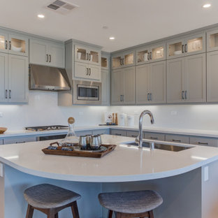 Open concept kitchen ideas - Open concept kitchen - l-shaped open concept kitchen idea in San Francisco with an undermount sink, recessed-panel cabinets, gray cabinets, stainless steel appliances and an island