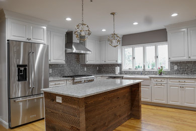 Example of a farmhouse kitchen design in New York with a farmhouse sink, raised-panel cabinets, white cabinets and quartzite countertops