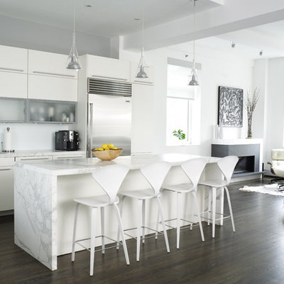 Example of a trendy open concept kitchen design in New York with white cabinets, marble countertops, stainless steel appliances, gray countertops and flat-panel cabinets