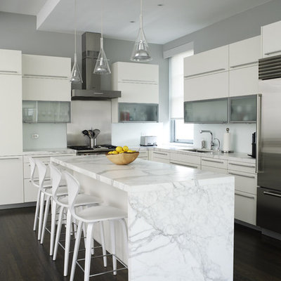 Inspiration for a contemporary l-shaped kitchen remodel in New York with stainless steel appliances, white cabinets, marble countertops and flat-panel cabinets