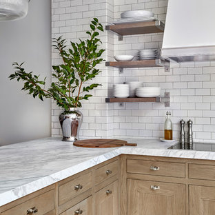 Design ideas for a transitional kitchen in Chicago with an undermount sink, recessed-panel cabinets, light wood cabinets, quartzite benchtops, white splashback, ceramic splashback, porcelain floors, a peninsula, multi-coloured floor and white benchtop.