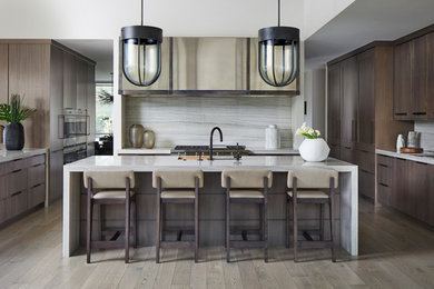 Example of a trendy light wood floor and gray floor eat-in kitchen design in Chicago with flat-panel cabinets, brown cabinets, quartzite countertops, gray backsplash, stone slab backsplash, colored appliances, an island and gray countertops