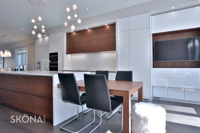 Example of a mid-sized danish galley eat-in kitchen design in Toronto with flat-panel cabinets, white cabinets, an island, quartz countertops, stone slab backsplash and paneled appliances