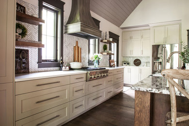 Example of a large classic single-wall medium tone wood floor and brown floor eat-in kitchen design in Indianapolis with a farmhouse sink, shaker cabinets, white cabinets, granite countertops, gray backsplash, ceramic backsplash, stainless steel appliances, an island and multicolored countertops