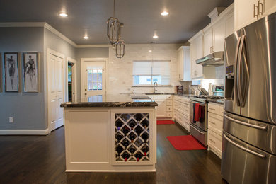 Eat-in kitchen - mid-sized transitional l-shaped dark wood floor eat-in kitchen idea in Dallas with a single-bowl sink, shaker cabinets, white cabinets, laminate countertops, white backsplash, stone tile backsplash, stainless steel appliances and an island