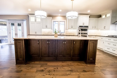 Inspiration for a transitional eat-in kitchen remodel in Omaha with beaded inset cabinets, white cabinets and an island